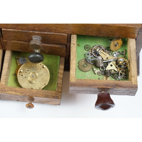 318 - A wooden watchmakers box together with contents to include wristwatches, pocket watches and parts.