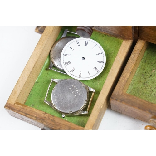 318 - A wooden watchmakers box together with contents to include wristwatches, pocket watches and parts.