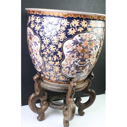 128 - Large Chinese fish bowl planter, decorated in the Imari palette, with panels depicting flowers spill... 