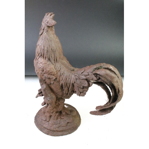 163 - Pair of cast iron garden cockerel ornaments, raised on circular bases, with oxidised finish. (Measur... 