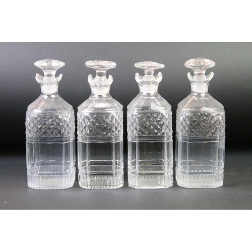 164 - Late 19th / early 20th C set of four cut glass decanters & stoppers raised on a silver plated stand ... 