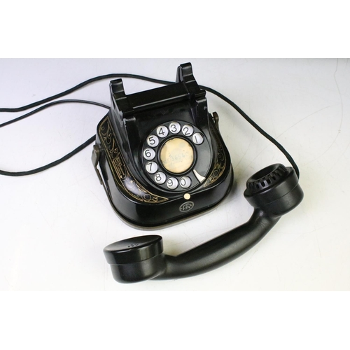 183 - 1940s Belgique bell telephone having a black body with gilt detailing, ring dial, bakelite receiver.... 