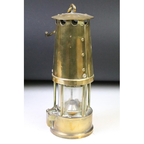 192 - Three brass cased Eccles miners lamps each with ' The Protector ' embossed labels to the front and h... 