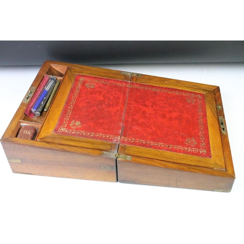 199 - Two Victorian wooden writing boxes, to include a campaign style rosewood example with brass fittings... 