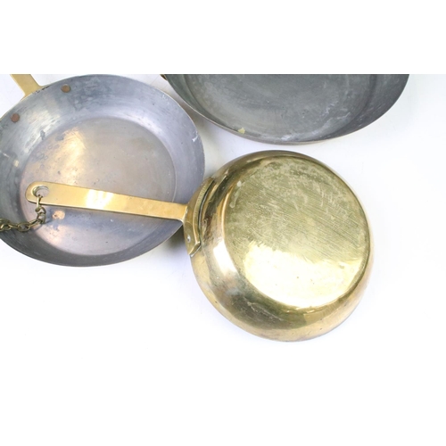 200 - Graduating set of four brass frying pans (largest diameter approx 23cm), together with a brass hand ... 