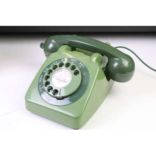 372 - Group of four late 20th Century ring dial plastic telephones in assorted colours.