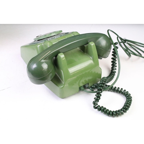 372 - Group of four late 20th Century ring dial plastic telephones in assorted colours.