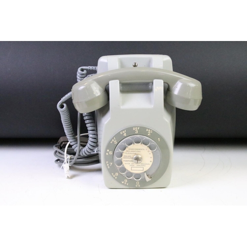 372 - Group of four late 20th Century ring dial plastic telephones in assorted colours.