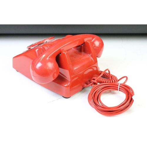 372 - Group of four late 20th Century ring dial plastic telephones in assorted colours.