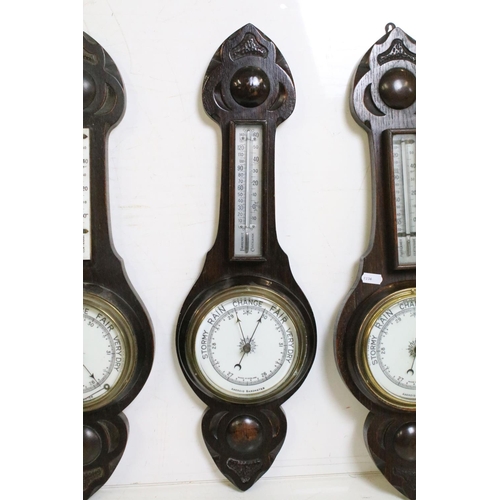 381 - Group of early 20th Century barometers to include three oak cased banjo aneroid barometers, and two ... 