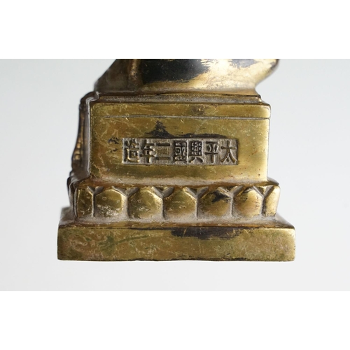 138 - Chinese gilt metal Buddhist figure with jewelled detail, raised on a hardwood stand with four feet. ... 