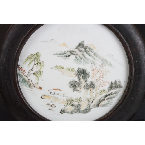 139 - Chinese pierced hardwood table screen, the circular enamel panel hand decorated with a mountainous l... 