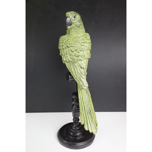 143 - Bronze figure of a green bird, possibly a crane, raised on a circular wooden plinth (approx 22.5cm h... 