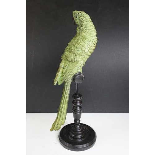 143 - Bronze figure of a green bird, possibly a crane, raised on a circular wooden plinth (approx 22.5cm h... 