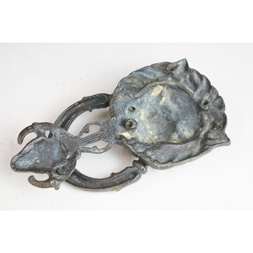 148 - Victorian cast metal door knocker having a lions head back plate with goat head suspended below and ... 