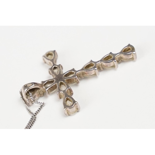 283 - A 925 sterling silver cross pendant set with clear stones, cross measures approx 4cm in length, chai... 