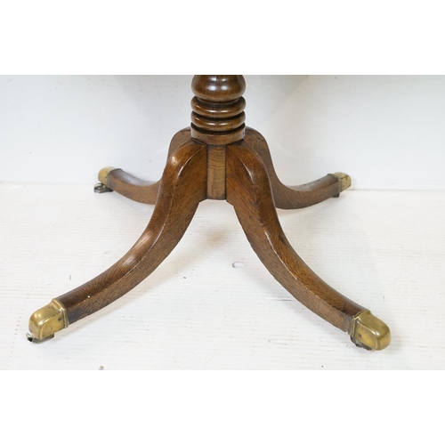 631 - George III Rectangular Oak Tilt Top Supper Table raised on a turned column support and four outswept... 