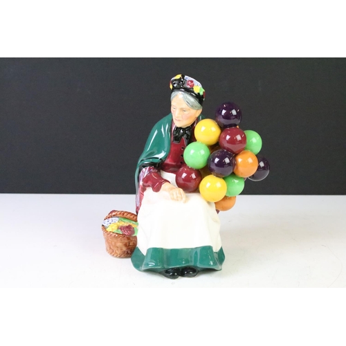 125 - Four Royal Doulton porcelain figurines to include The Old Balloon Seller (HN1315), Autumn Breeze (HN... 