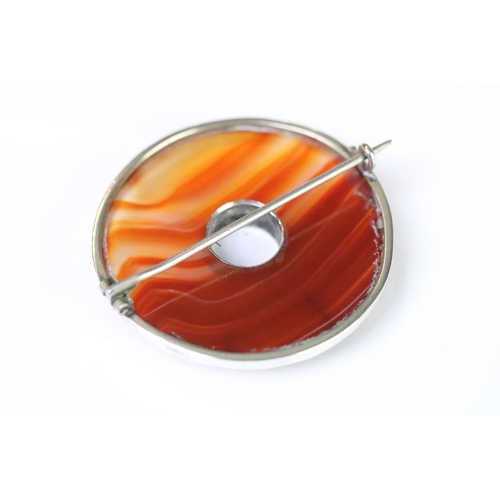 238 - A Victorian Scottish silver and carnelian brooch of circular form, unmarked white metal tests as sil... 