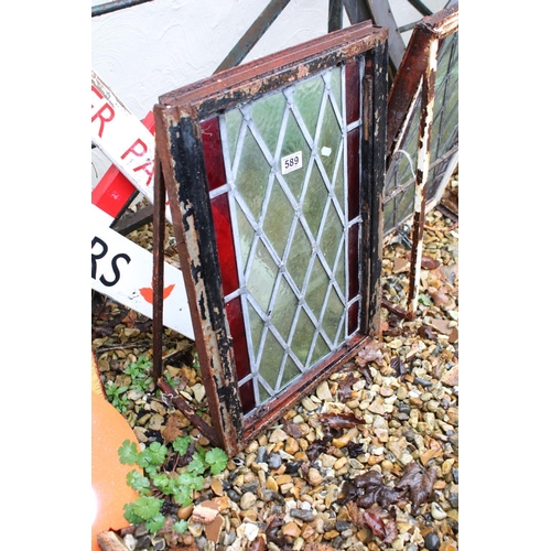 589 - Pair of leaded stained glass windows, within wrought iron frames, measure approx 59cm x 40cm