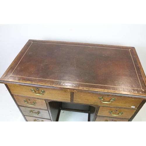 602 - George III style Mahogany Kneehole Desk, the brown leather inset top over an arrangement of eight dr... 