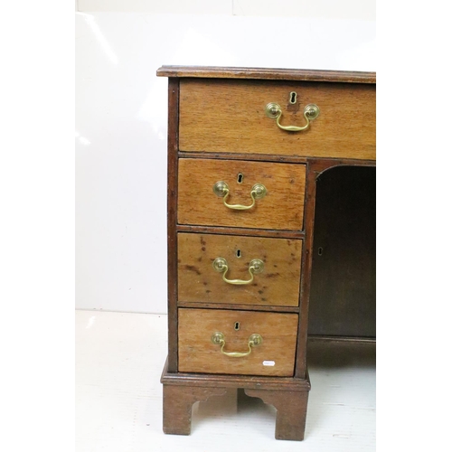 602 - George III style Mahogany Kneehole Desk, the brown leather inset top over an arrangement of eight dr... 