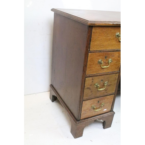 602 - George III style Mahogany Kneehole Desk, the brown leather inset top over an arrangement of eight dr... 