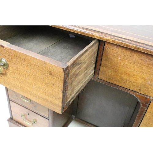 602 - George III style Mahogany Kneehole Desk, the brown leather inset top over an arrangement of eight dr... 