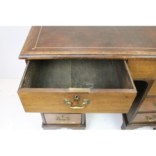 602 - George III style Mahogany Kneehole Desk, the brown leather inset top over an arrangement of eight dr... 