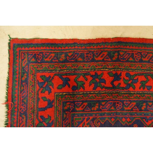 613 - Large Wool Red Ground Rug with central geometric pattern motif and border to edge, 320cm x 373cm