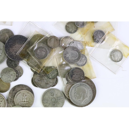 157 - A collection of British pre decimal and world silver coins to include Queen Victoria and King George... 