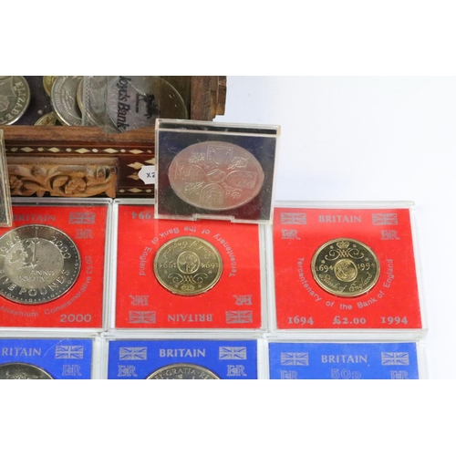 163 - A collection of British commemorative coins to include uncirculated commemorative crowns within caps... 