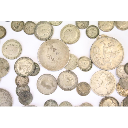 31 - A collection of British pre decimal silver coins to include Crowns, half crowns, florins, threepence... 