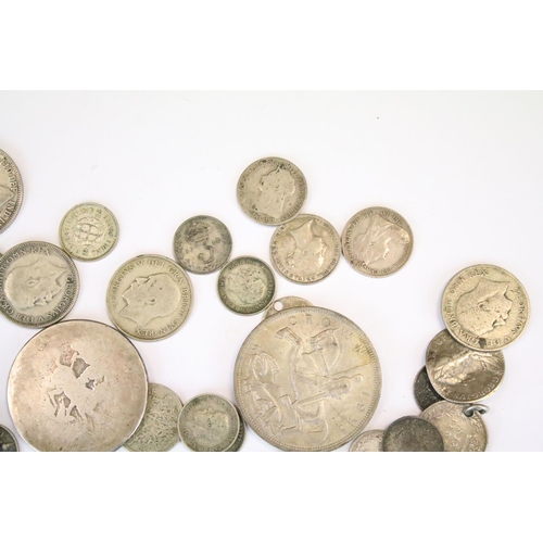 31 - A collection of British pre decimal silver coins to include Crowns, half crowns, florins, threepence... 