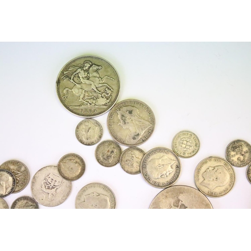 31 - A collection of British pre decimal silver coins to include Crowns, half crowns, florins, threepence... 