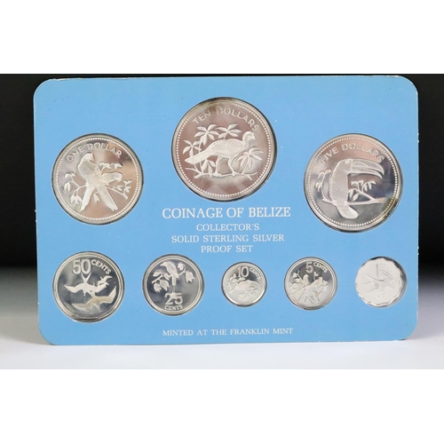 49 - A collection of three Franklin Mint proof coin sets to include The first coinage of Papua New Guinea... 