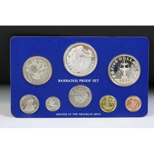 49 - A collection of three Franklin Mint proof coin sets to include The first coinage of Papua New Guinea... 