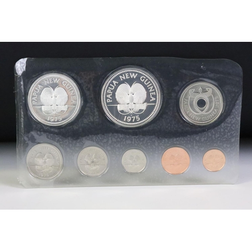 49 - A collection of three Franklin Mint proof coin sets to include The first coinage of Papua New Guinea... 