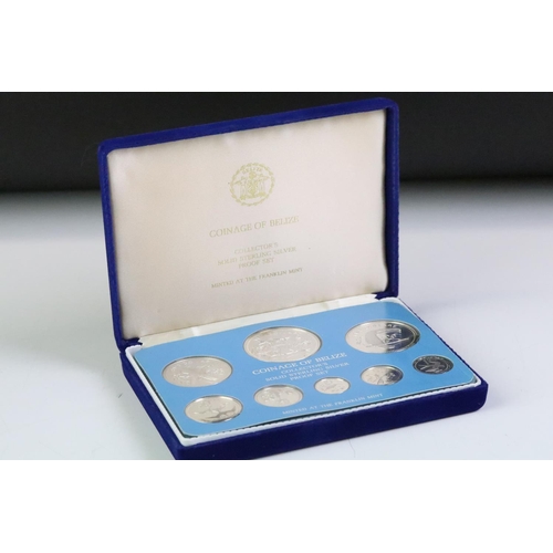 49 - A collection of three Franklin Mint proof coin sets to include The first coinage of Papua New Guinea... 