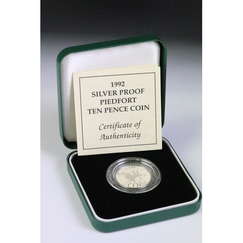 95 - A collection of three silver proof coin sets to include the 1982 silver proof piedfort 20p coin, the... 