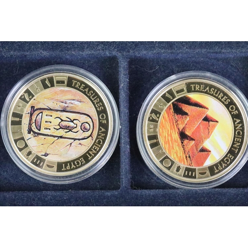 214 - A collection of Egypt commemorative coins encapsulated and within display case together with a selec... 