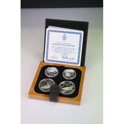 18 - A collection of seven Canada silver proof Olympic coin sets, all within fitted display boxes and com... 