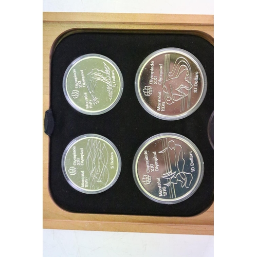 18 - A collection of seven Canada silver proof Olympic coin sets, all within fitted display boxes and com... 