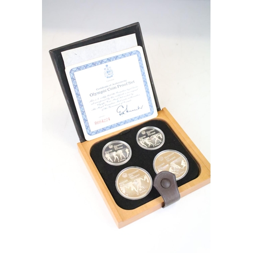 18 - A collection of seven Canada silver proof Olympic coin sets, all within fitted display boxes and com... 