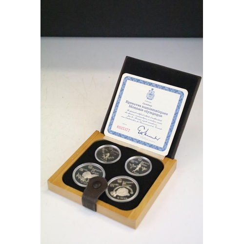 18 - A collection of seven Canada silver proof Olympic coin sets, all within fitted display boxes and com... 