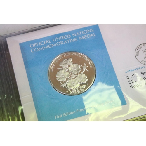 19 - A collection of ten United Nations silver proof coin covers contained within three albums.