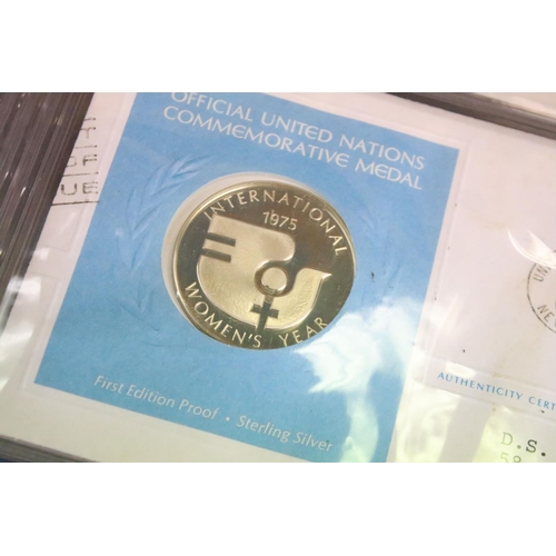 19 - A collection of ten United Nations silver proof coin covers contained within three albums.