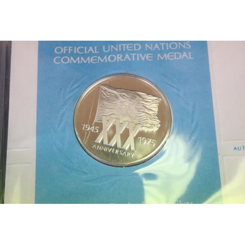 19 - A collection of ten United Nations silver proof coin covers contained within three albums.