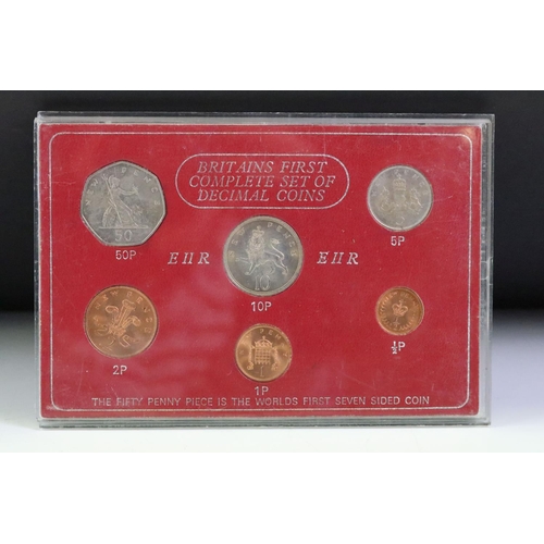 76 - A collection of seven mounted coin sets to include 1967 Coinage of G.B., 1965 EIIR set, Farewell to ... 