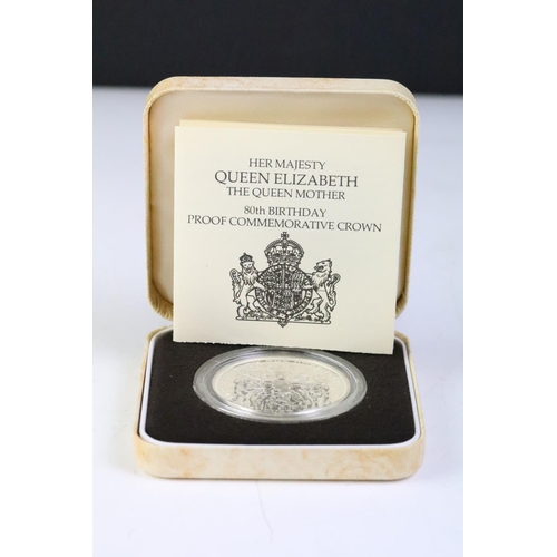 235 - A collection of four Royal Mint United Kingdom commemorative crown coins to include the 1980 Queen M... 